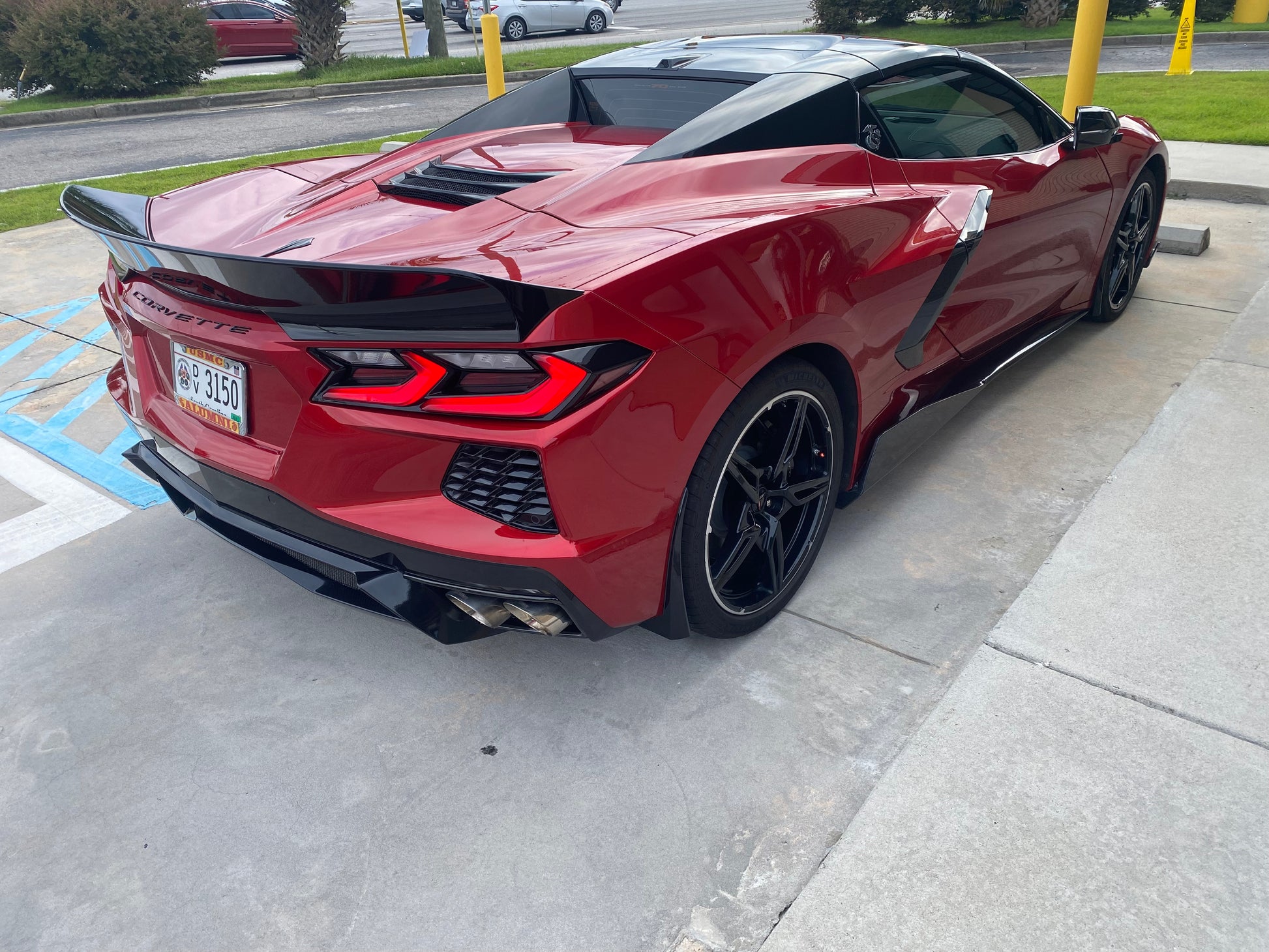 Charles girl Ravens 2023 Corvette Stingray 2LT in red-mist-metallic-tintcoat