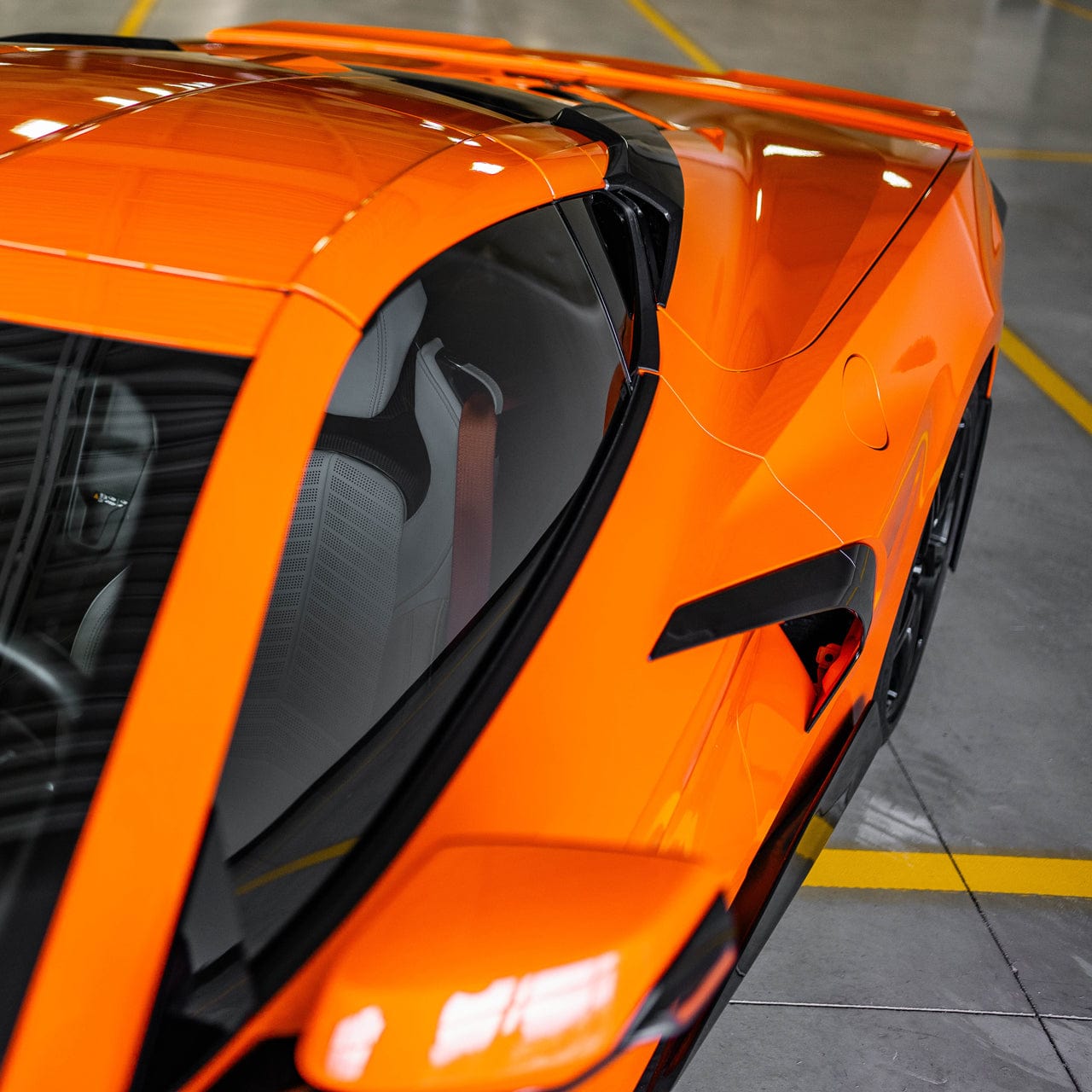 Head on shot of the ACS C8 RQ Intake Ports in Carbon Flash Black installed on a Sebring Orange C8 Corvette Stingray