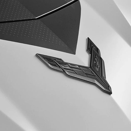 C8 Dark Stealth Crossed Flags Emblem in Carbon Flash Black for Corvette, SKU 50-4-140. Upgrade your vehicle's appearance with this genuine GM part.