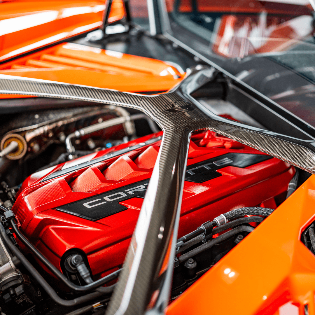 C8 Corvette Edge Red Engine Cover installed under a Carbon Fiber X-Brace