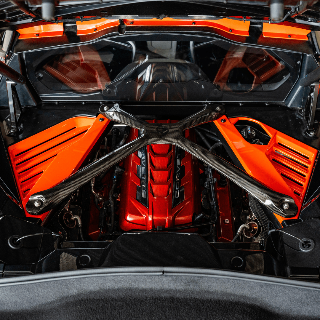 Opened C8 Corvette Coupe engine compartment with Sebring Orange components installed