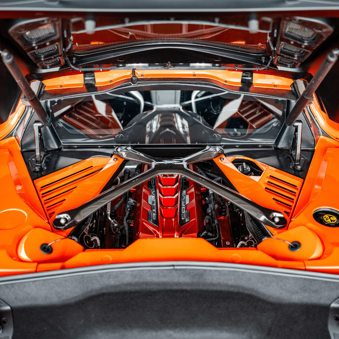 Opened C8 Corvette Coupe engine compartment with Sebring Orange components installed